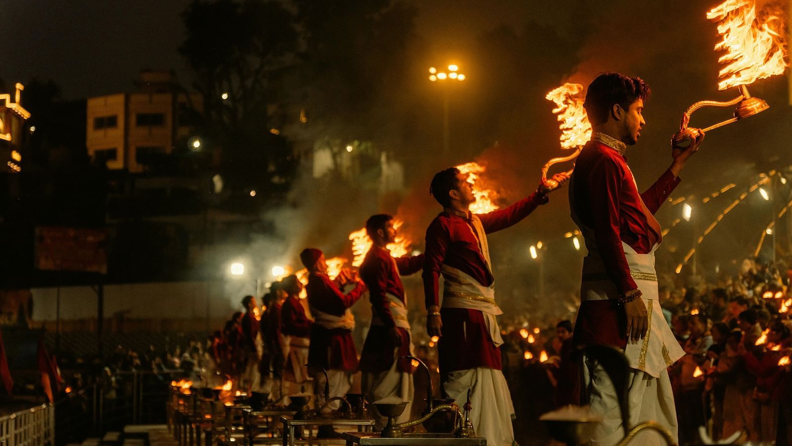 priests lined up performing ganga arti in the late evening at rishikesh