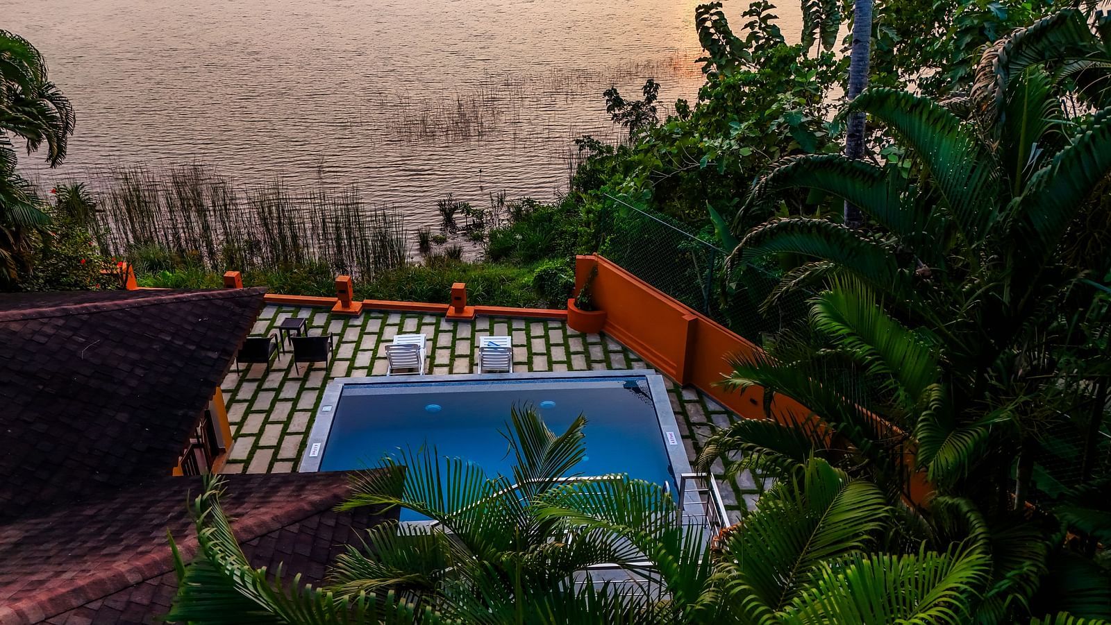 Private pool with a view of the lake at a resort.