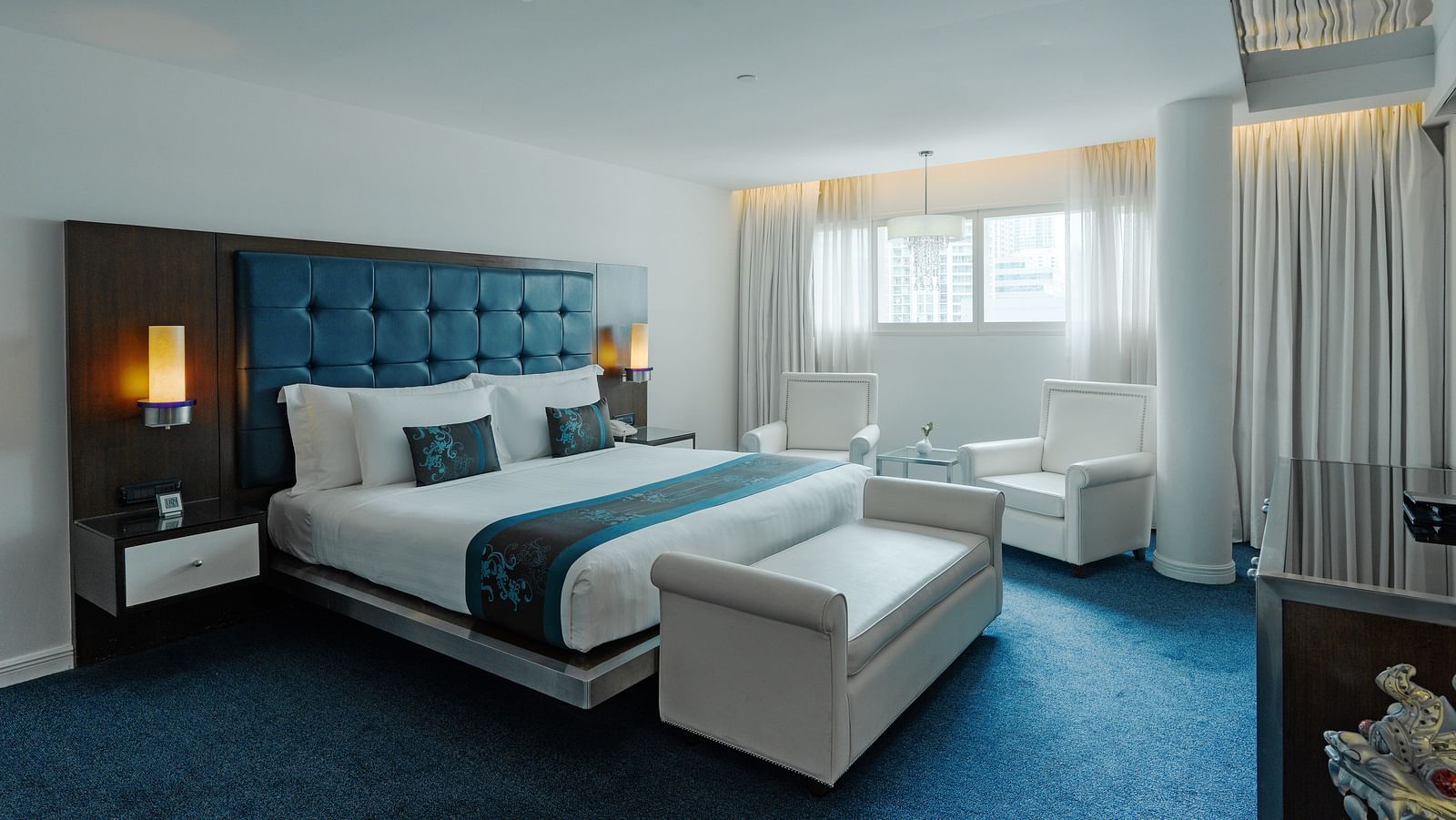 a double bed with side tables and lamps inside Platinum Suite at Night Hotel Bangkok