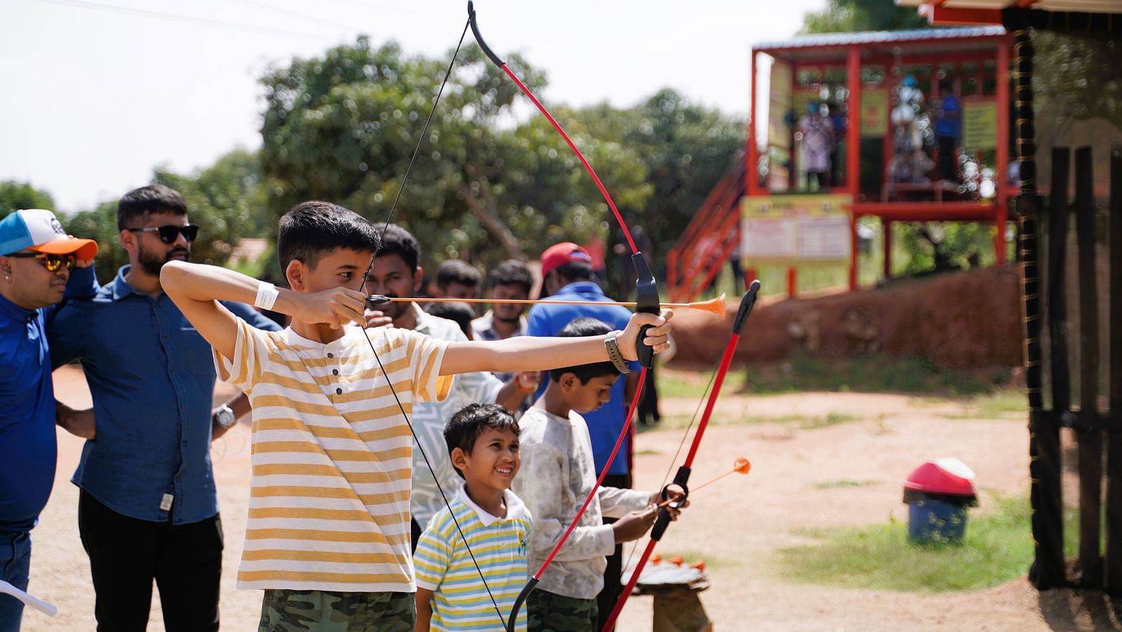 An image of a teen boy along with a little boy playing archery at Ravishing Retreat