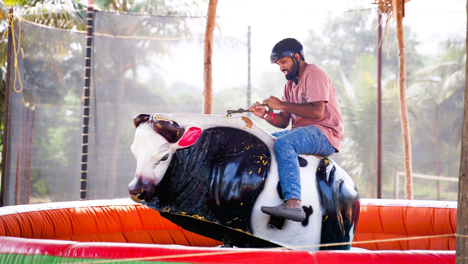 A person enjoying bull ride at Ravishing Retreat on a sunny day