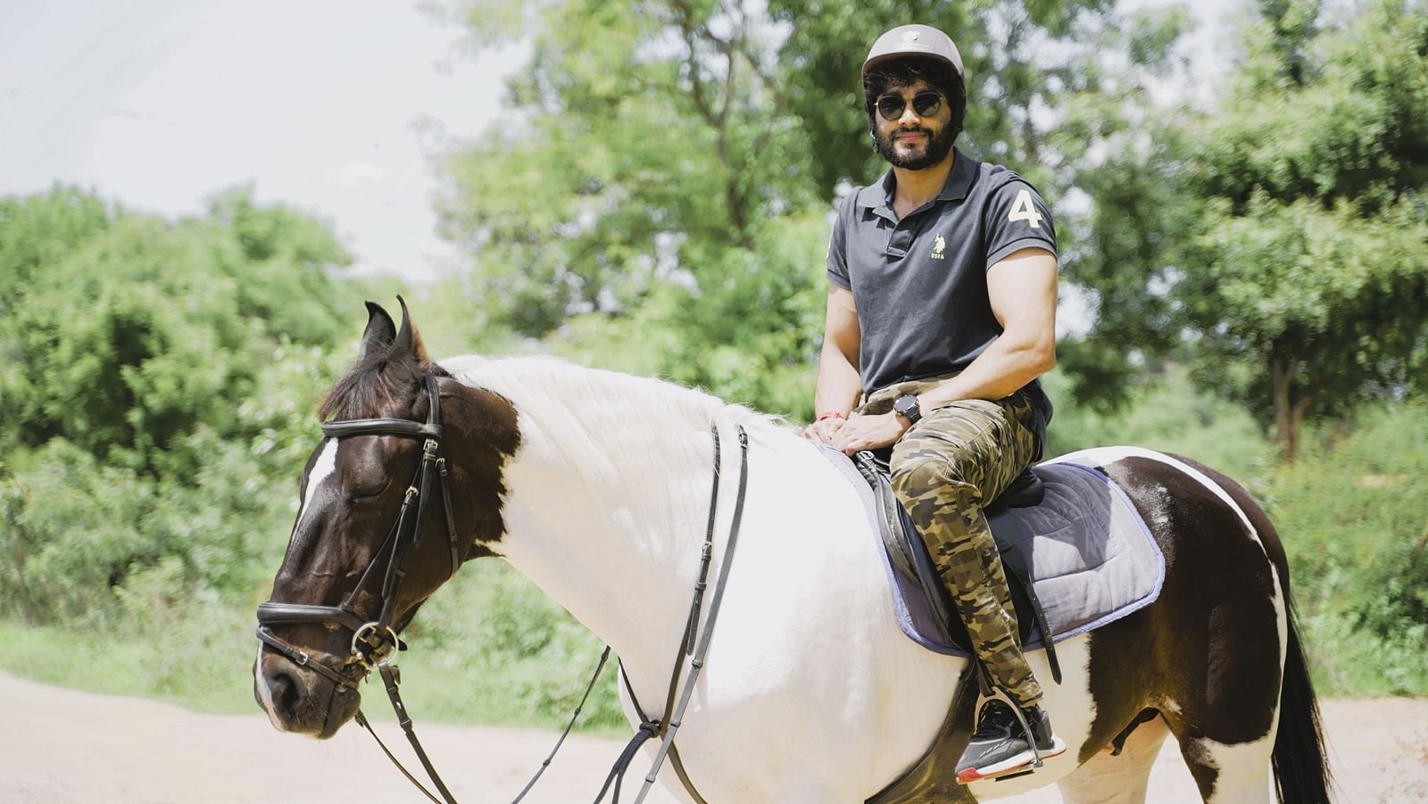 An image of a man smiling into the camera on a horse at Ravishing Retreat