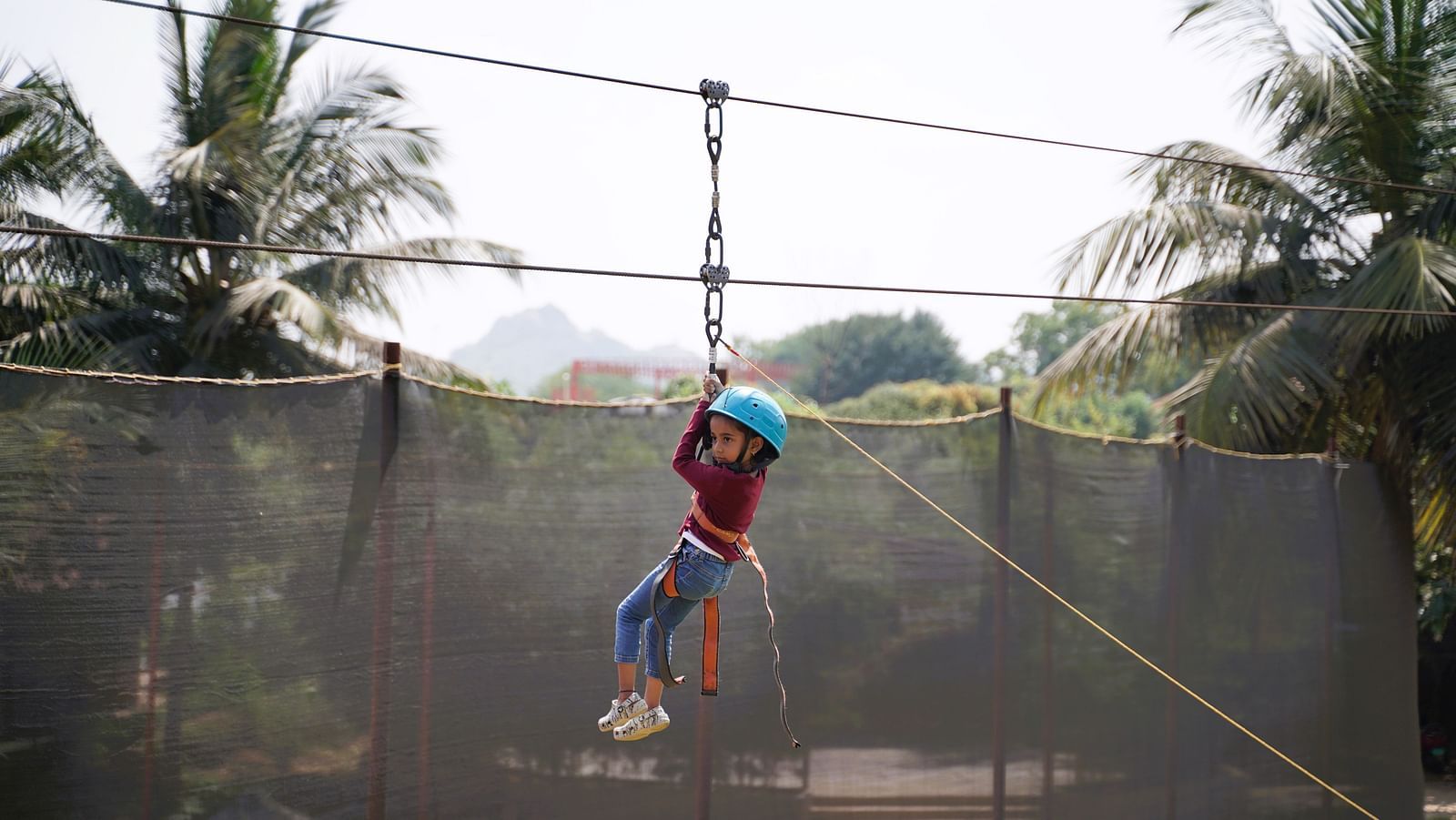 An image of a little girl enjoying zip line at Ravishing Retreat