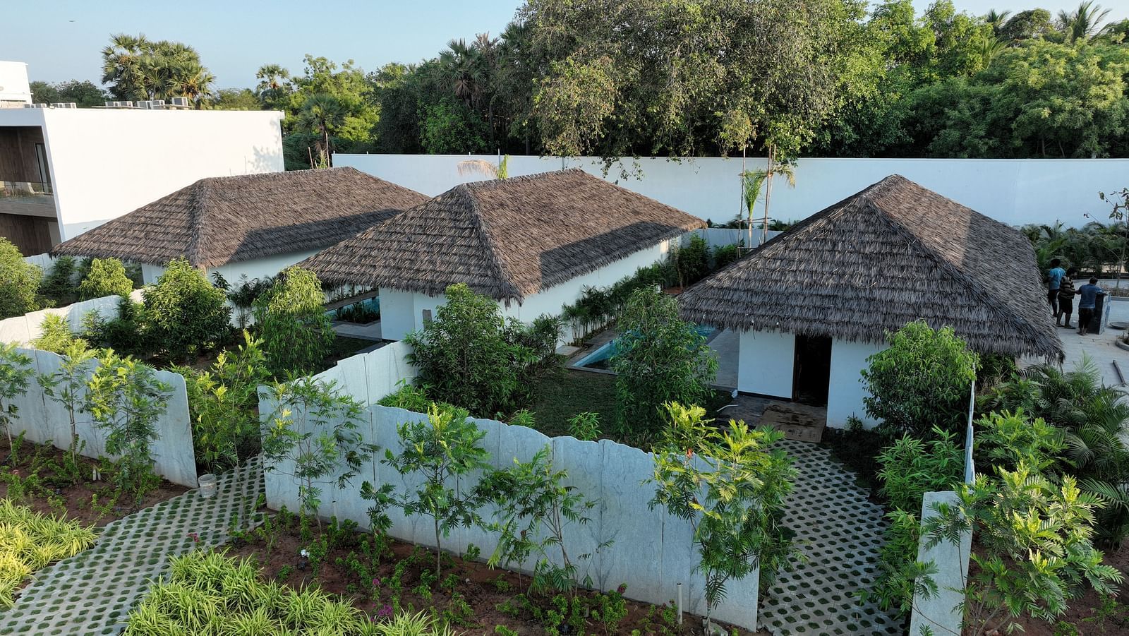 Side view of the exterior of the elegant cottages at The Shore Trishvam, Pondicherry surrounded by lush greenery.