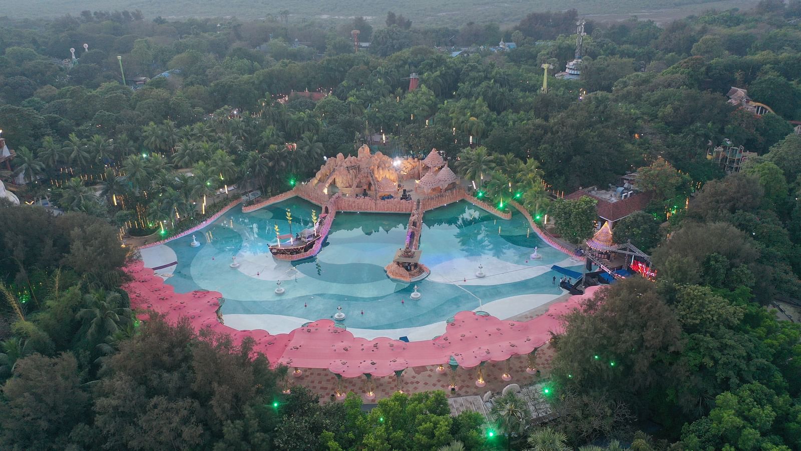 An aerial view of a water park surrounded by lush greenery at Water Kingdom.