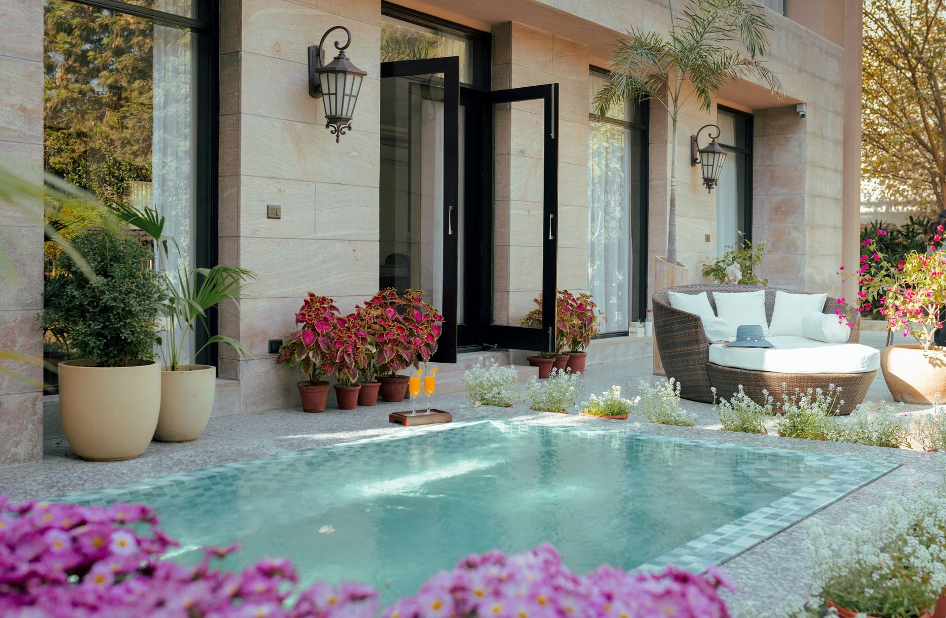 Outdoor villa view with a private plunge pool and floral decor at Karma Chalets.