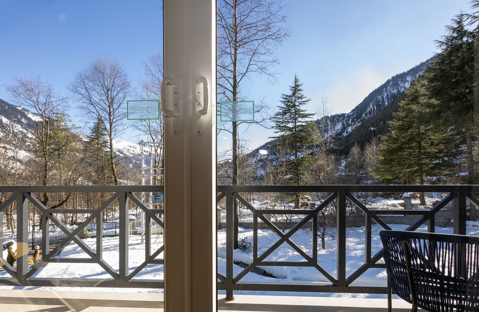 Balcony with railings overlooking a snowy landscape at Nivasana Manali.