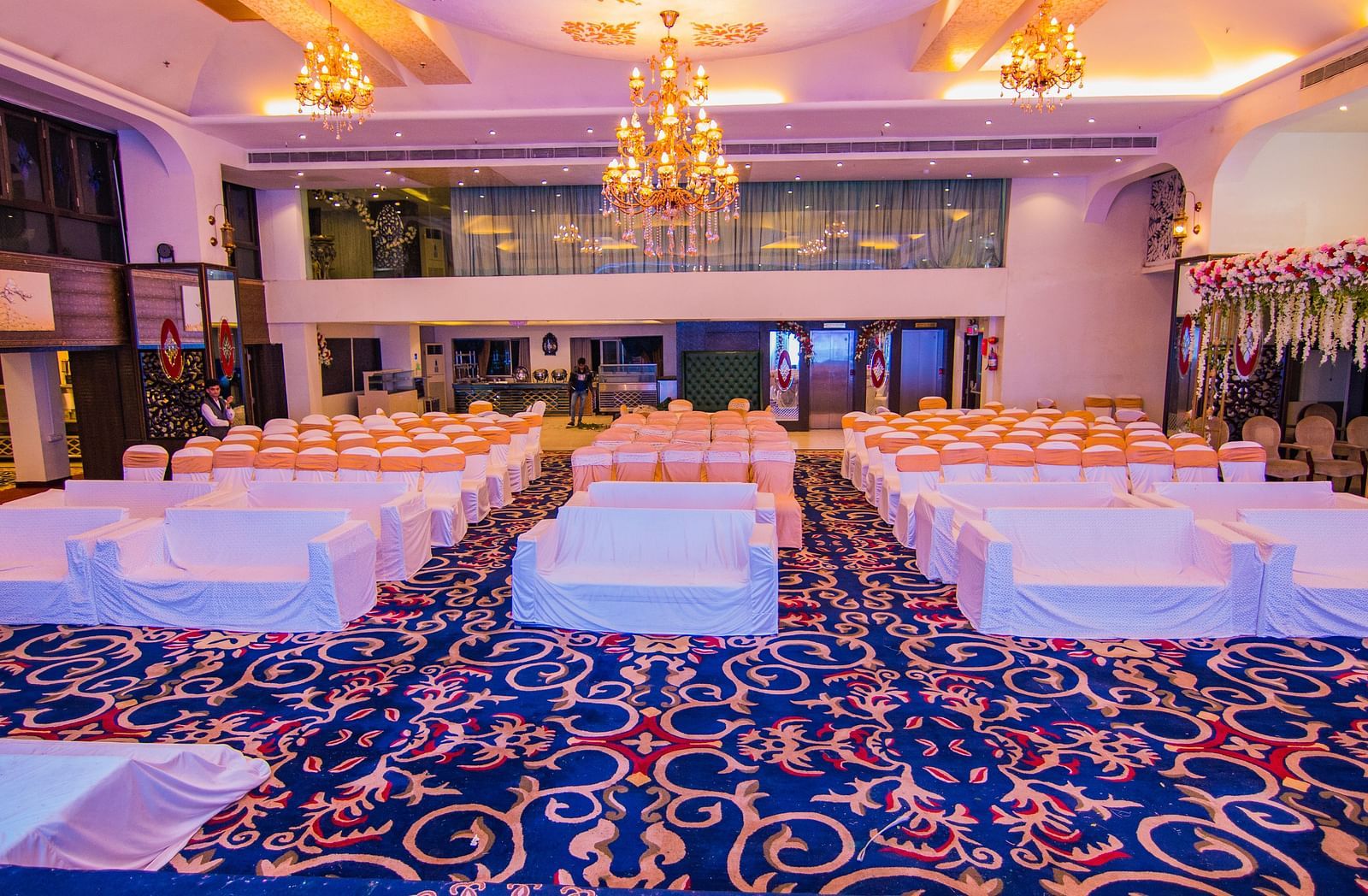 Kohinoor featuring blue patterned carpet and rows of chairs.