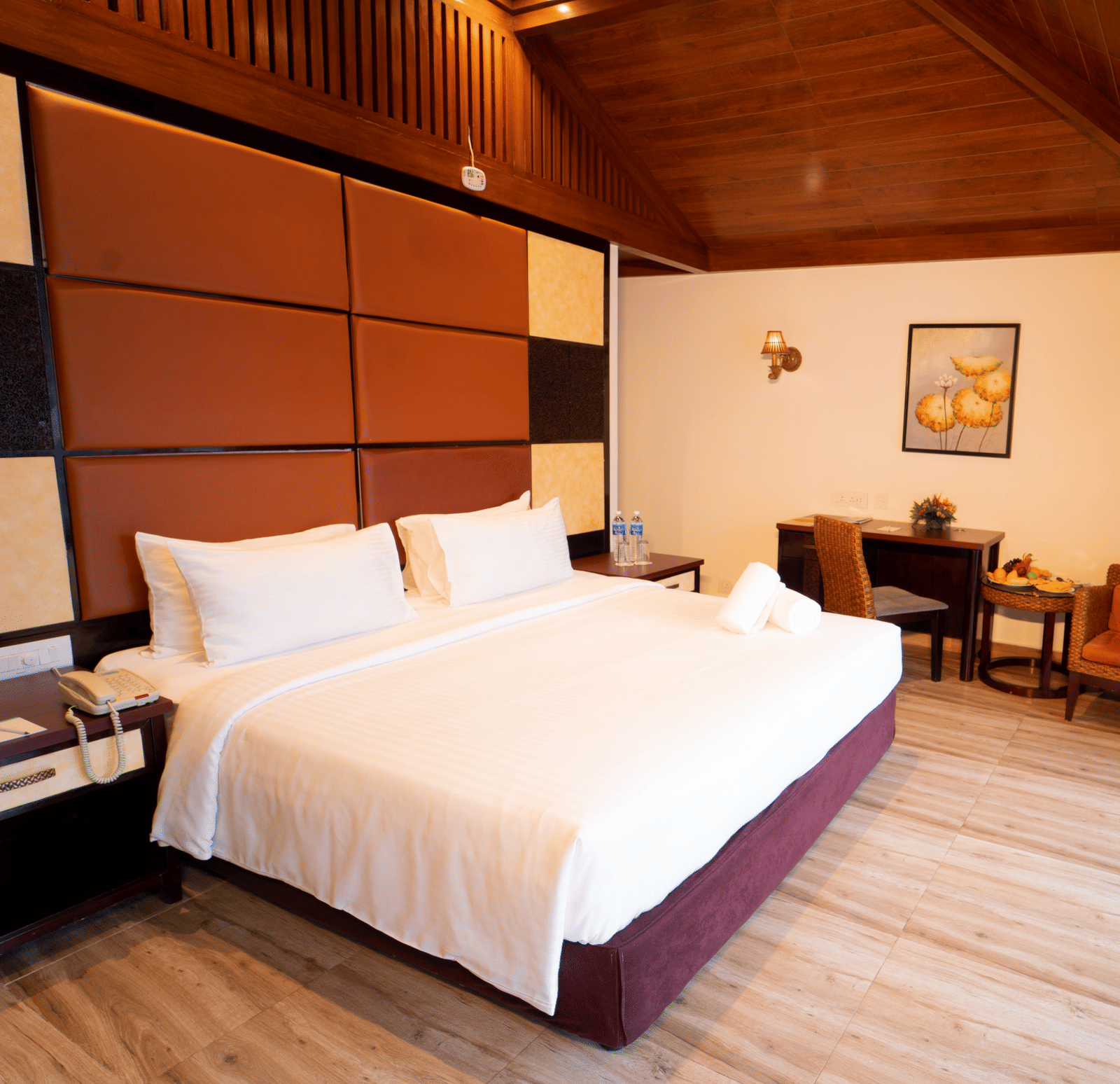 Santorini Villa with a balcony, queen size bed and wooden headboard at Ocean Spray Puducherry