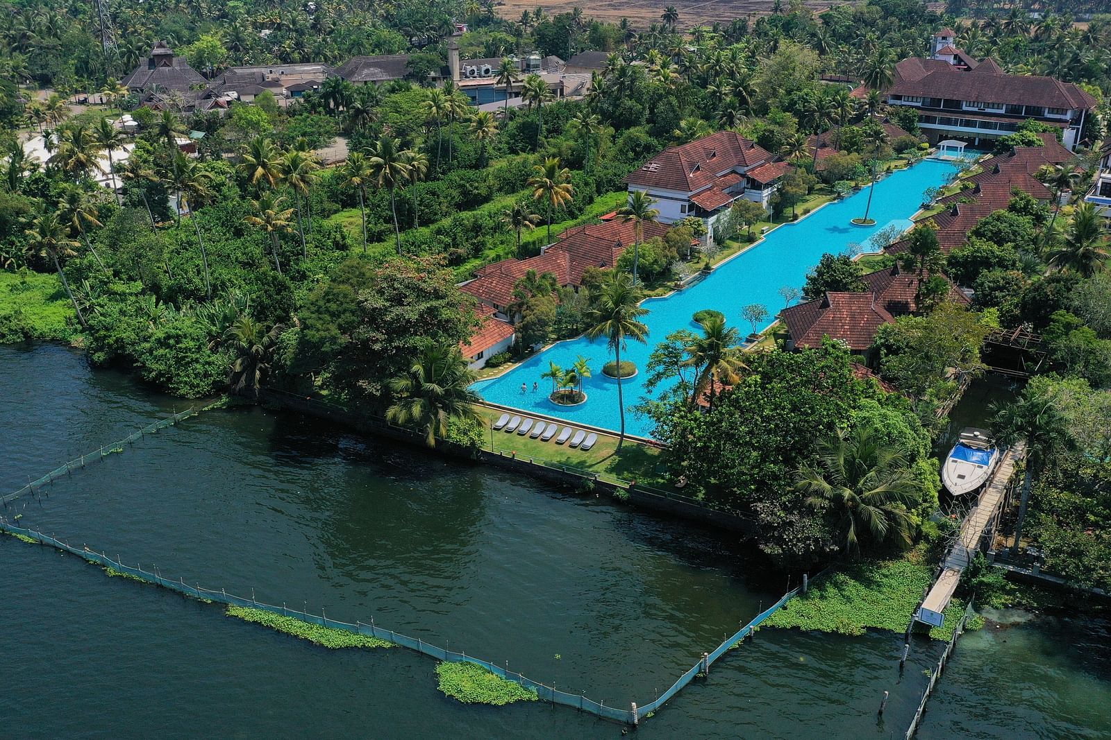a bird's eye view of Rhythm Kumarakom with the backwaters and swimming pool in view.