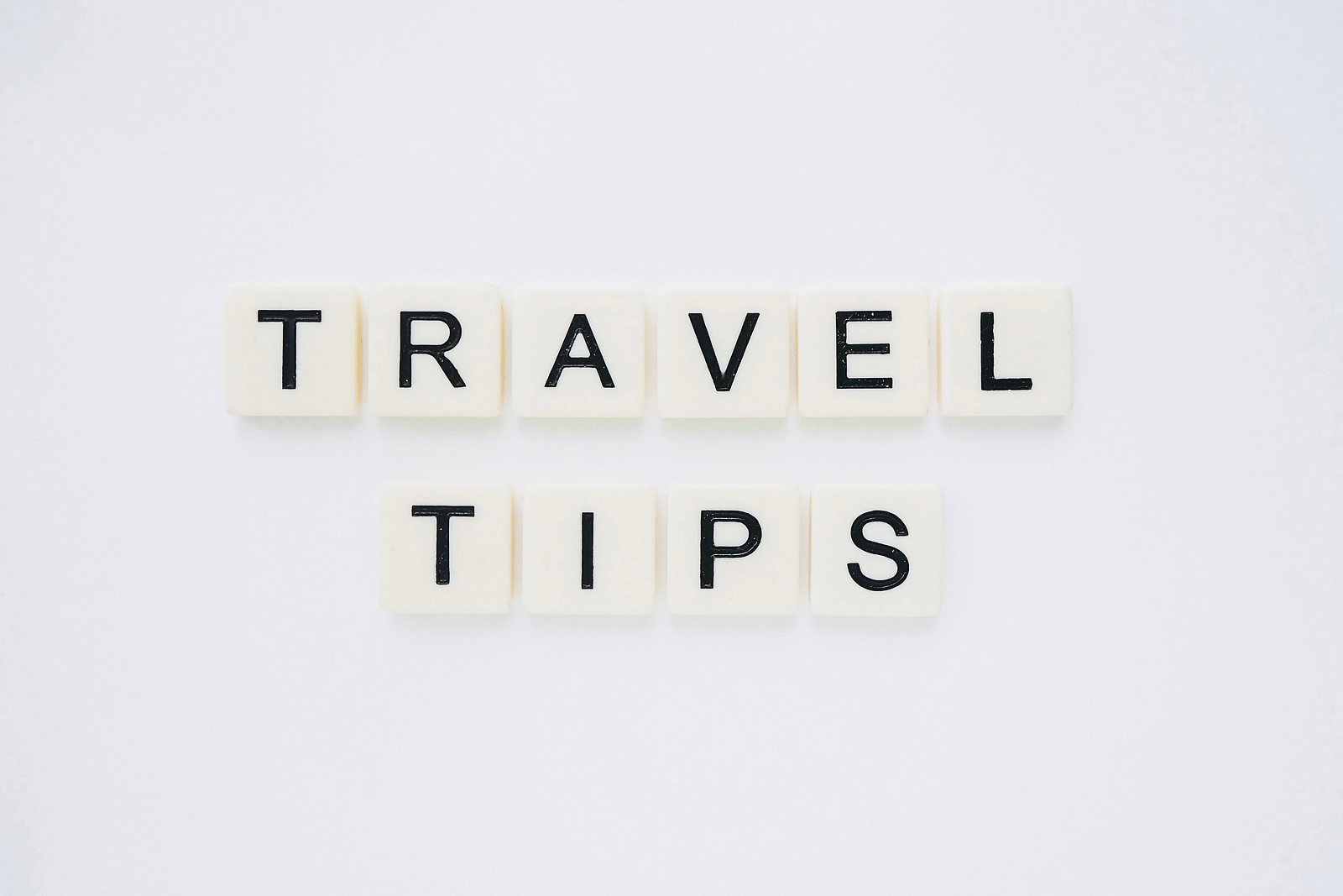 The word Travel Tips made out of scrabble tiles and placed on a table.