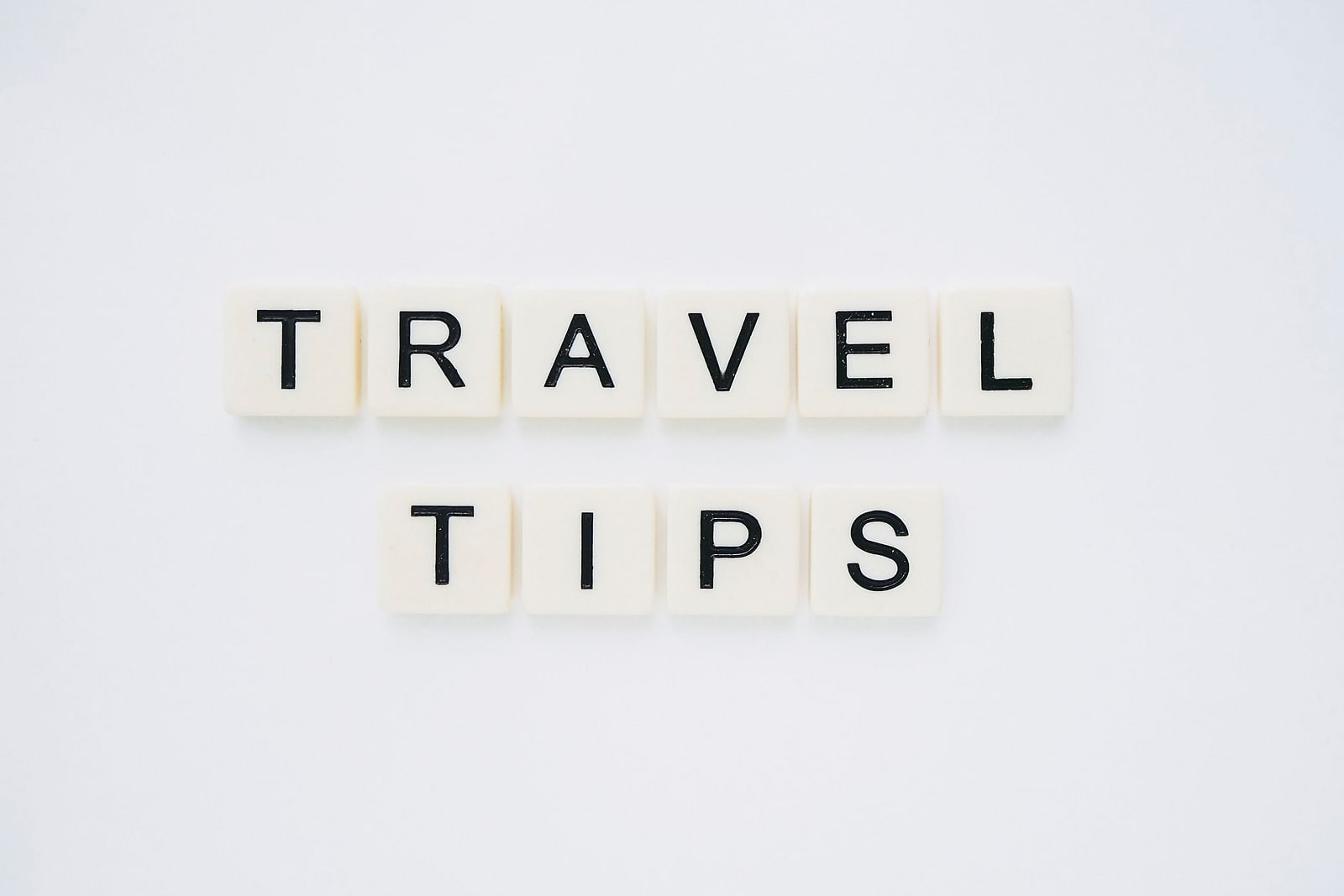 The word Travel Tips made out of scrabble tiles and placed on a table.