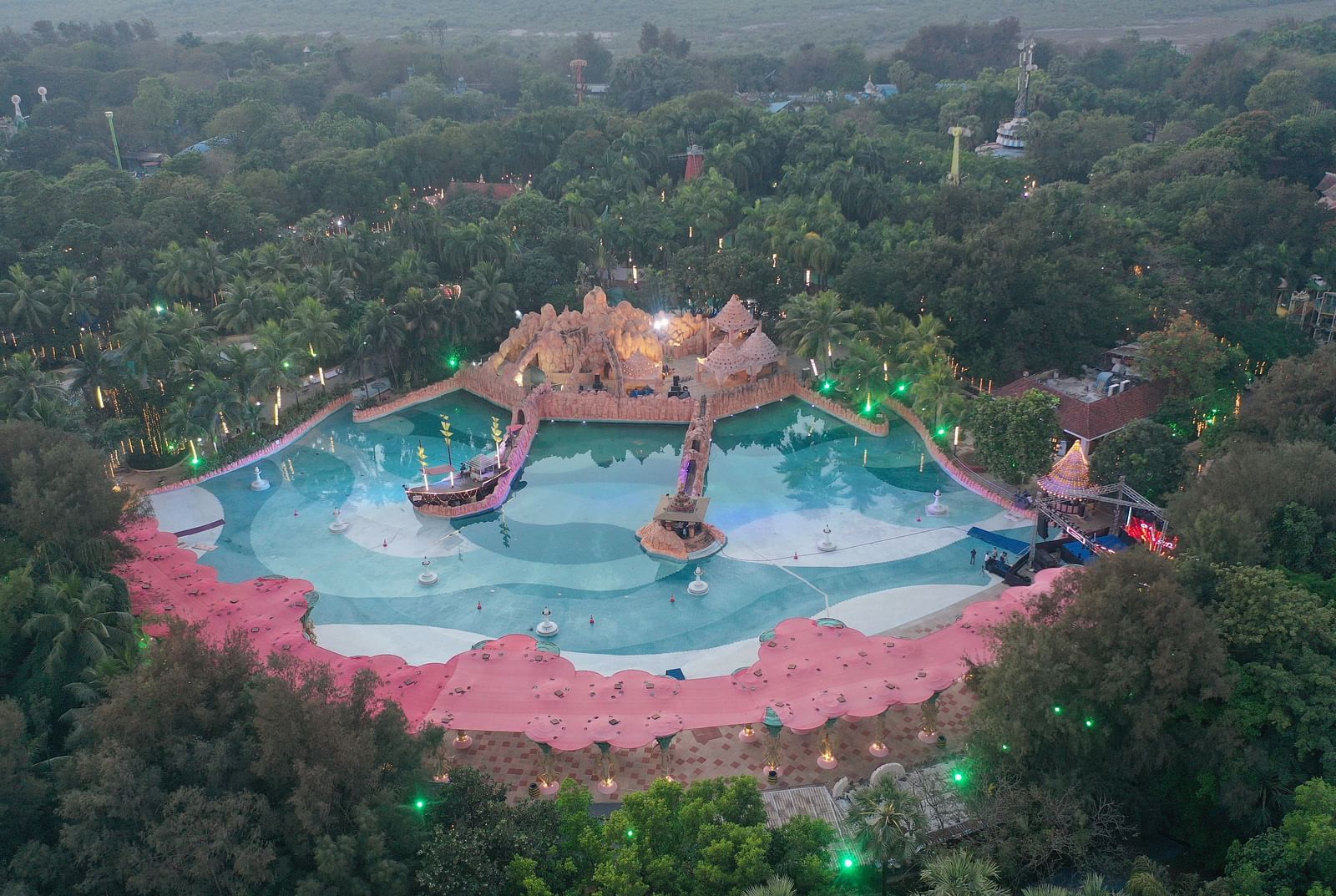 An aerial view of a water park surrounded by lush greenery at Water Kingdom.