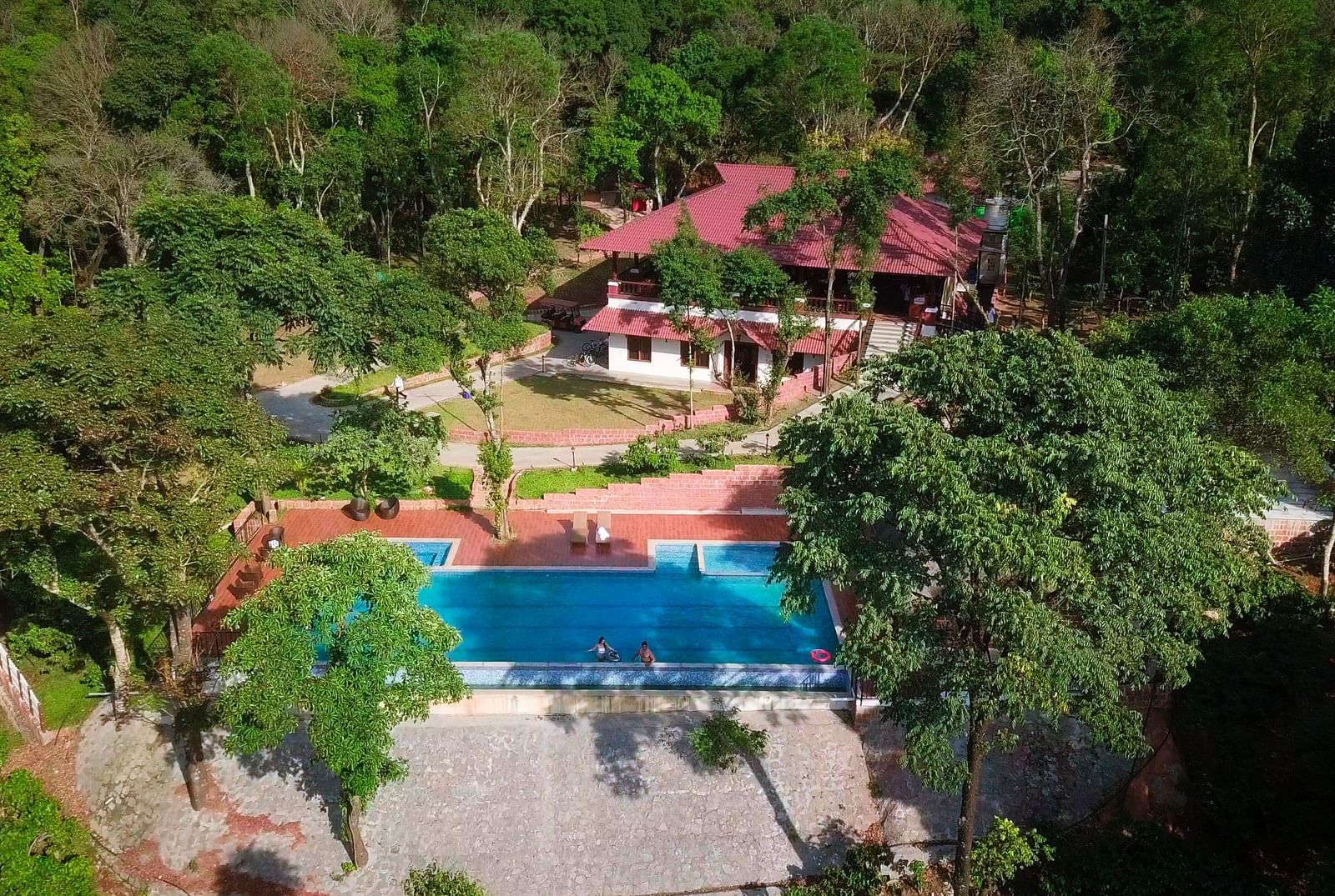 An aerial view of a resort with a swimming pool