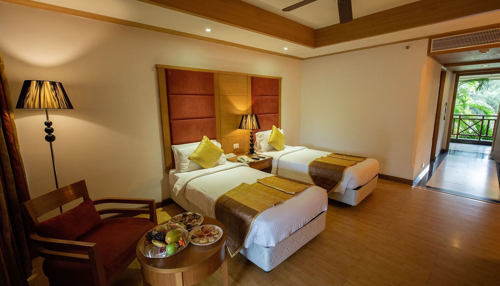 OS-CASCADE room with twin bed and wooden headboard at Ocean Spray Puducherry