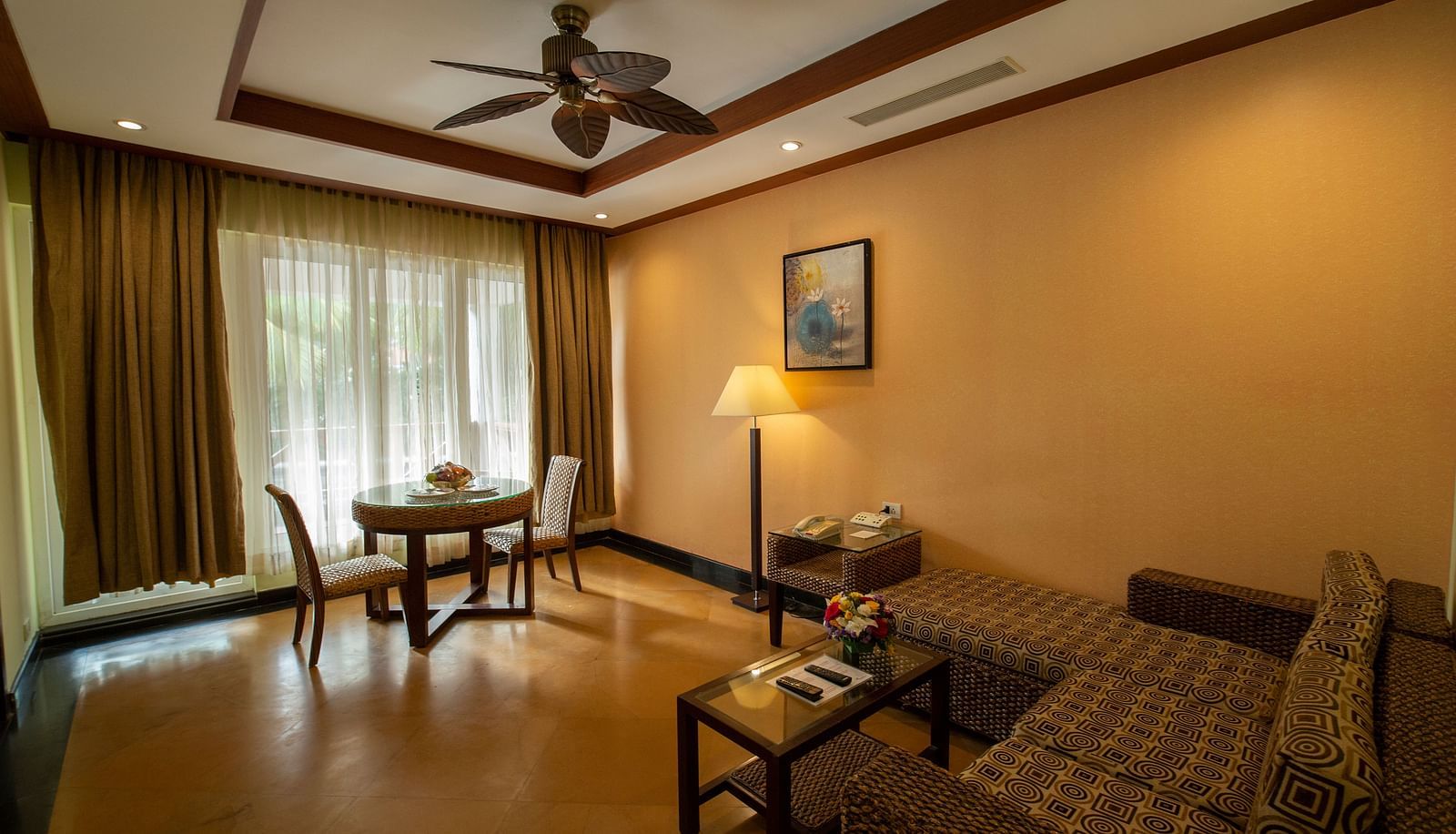 GUADELOUPE Luxury Villa Living room with a dining table for two and sofa at Ocean Spray Puducherry