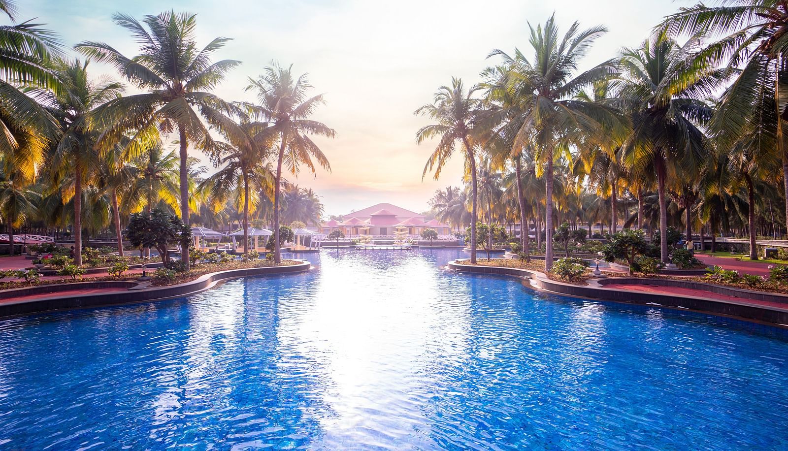 Swimming Pool view with sun reflecting on the water at Ocean Spray Puducherry