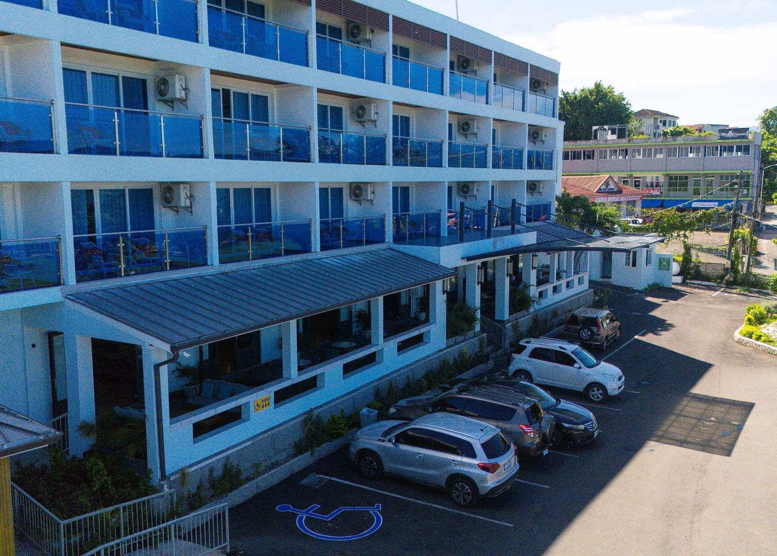 A drone shot of our Hotel 39 @ Jamaica with cars parked in front of it - Hotel 39, Jamaica (Montego Bay)