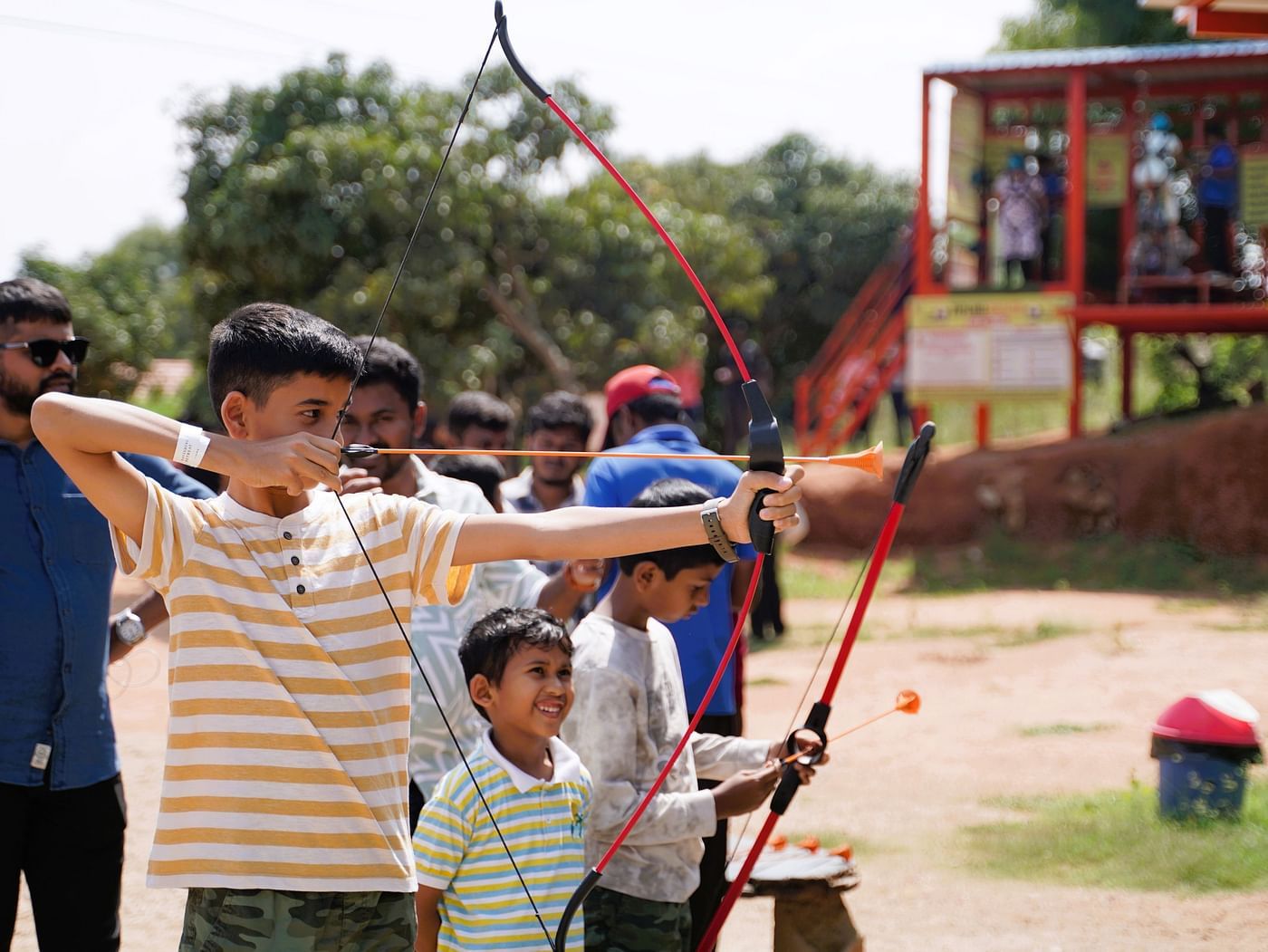 An image of a teen boy along with a little boy playing archery at Ravishing Retreat