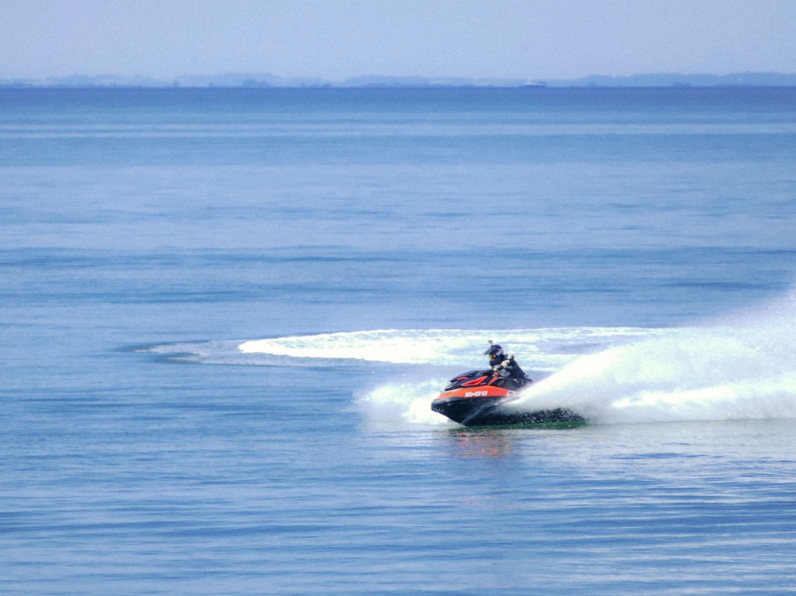 An image of a person travelling on a speed boat and having a thrilling time