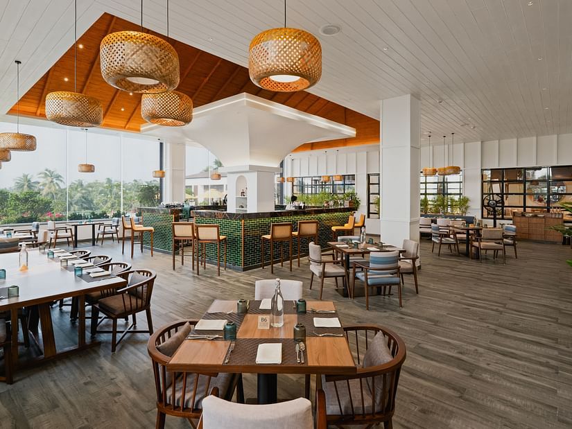 Rooftop dining space with plants arranged in the corners at Cloud9 Sarovar Premiere, Palolem Goa