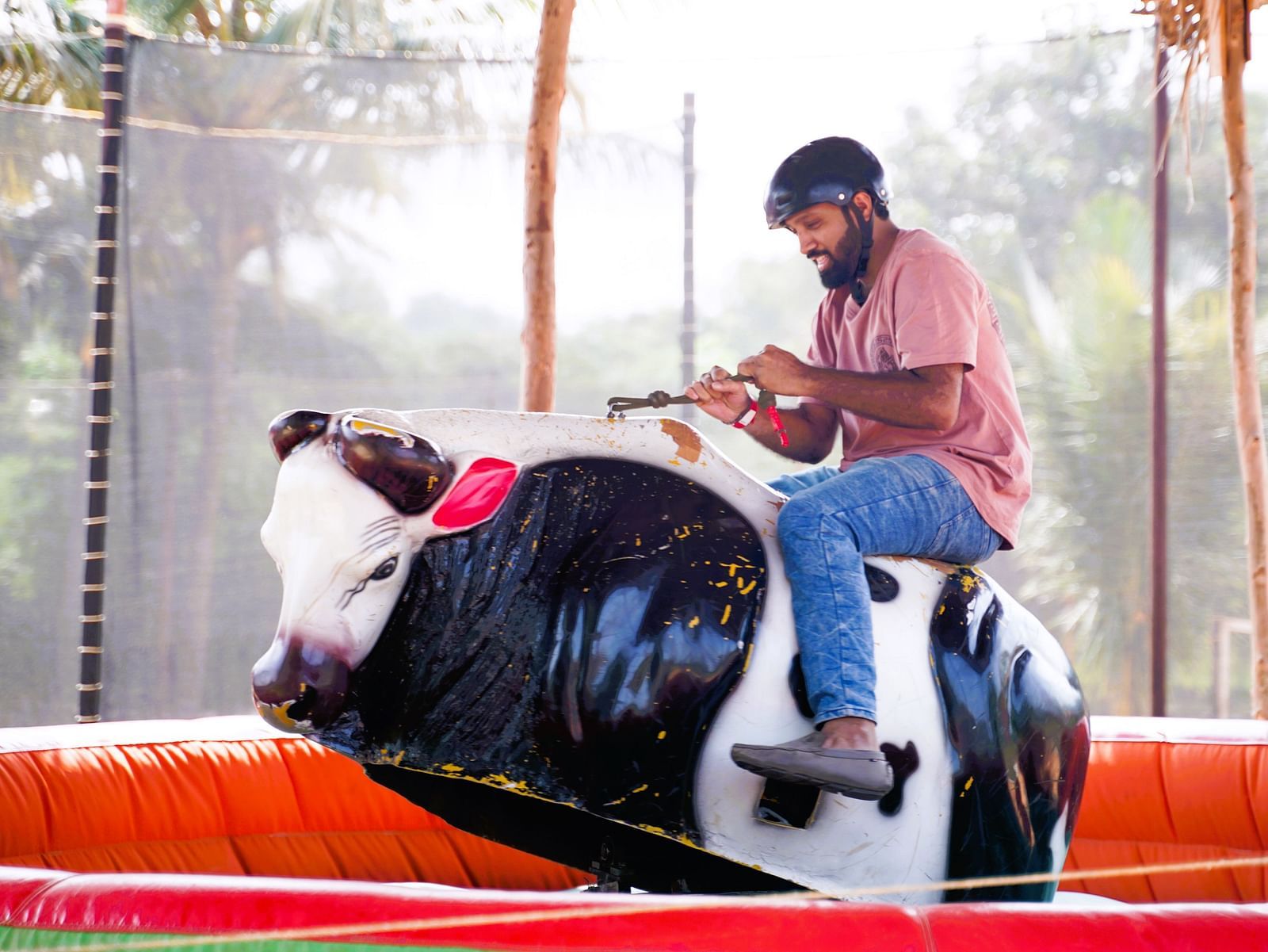 A person enjoying bull ride at Ravishing Retreat on a sunny day