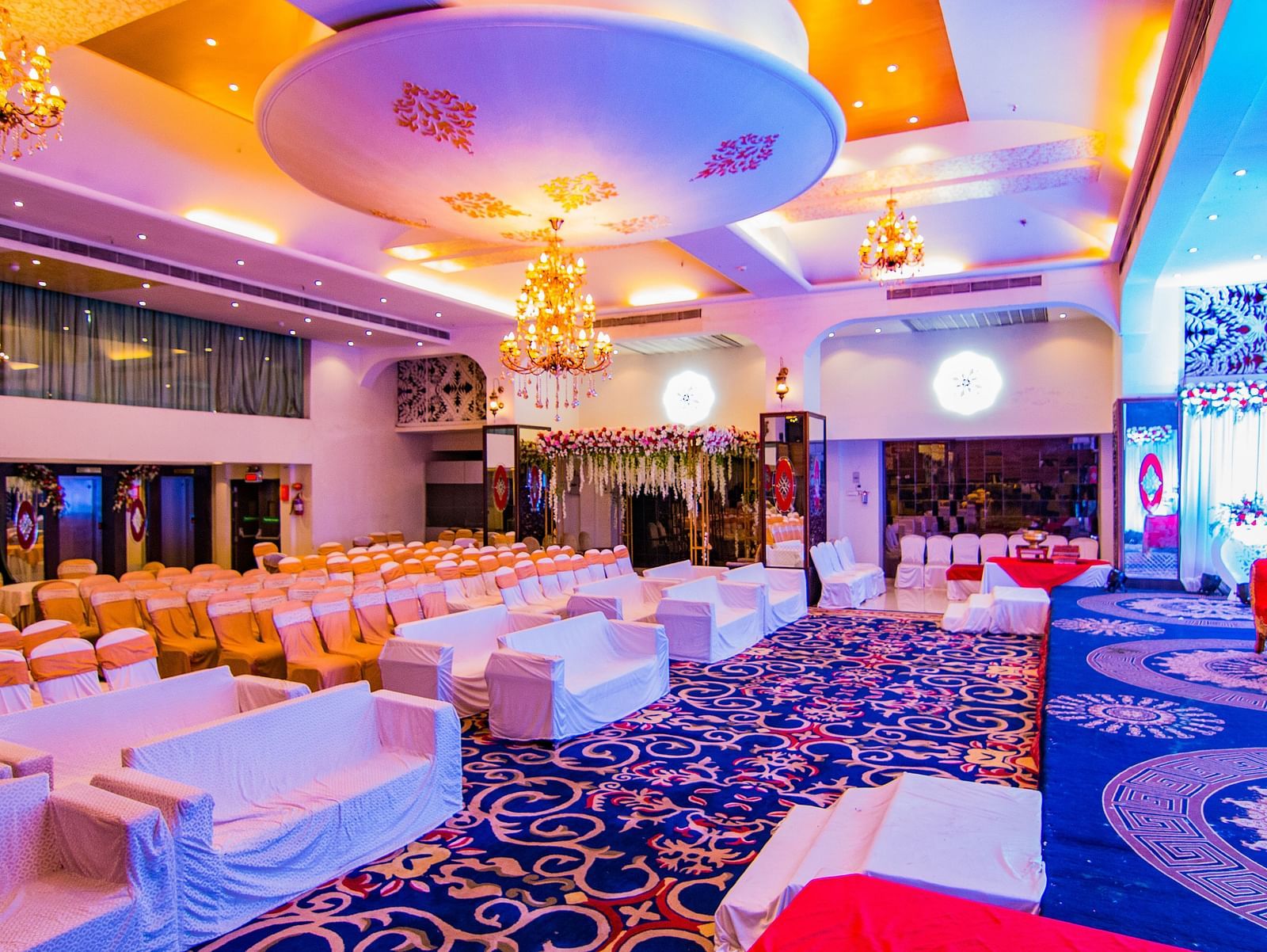 Kohinoor highlighting the stage area and rows of chairs facing the stage.