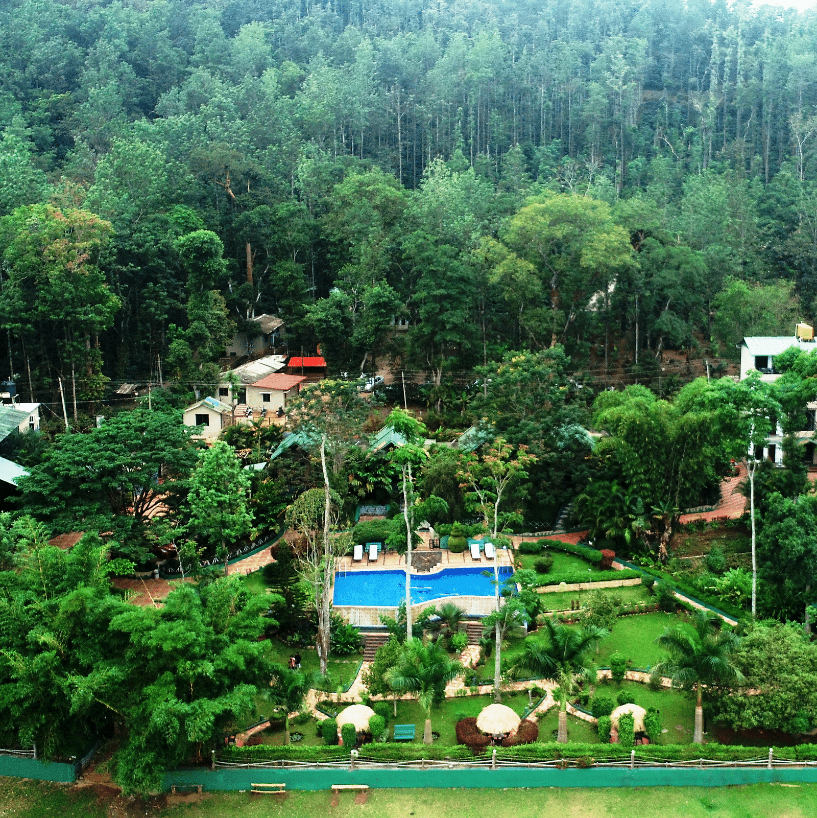 Aerial view of Coorg Jungle Camp Backwater Resort, Kushalnagar surround by lush greenery.