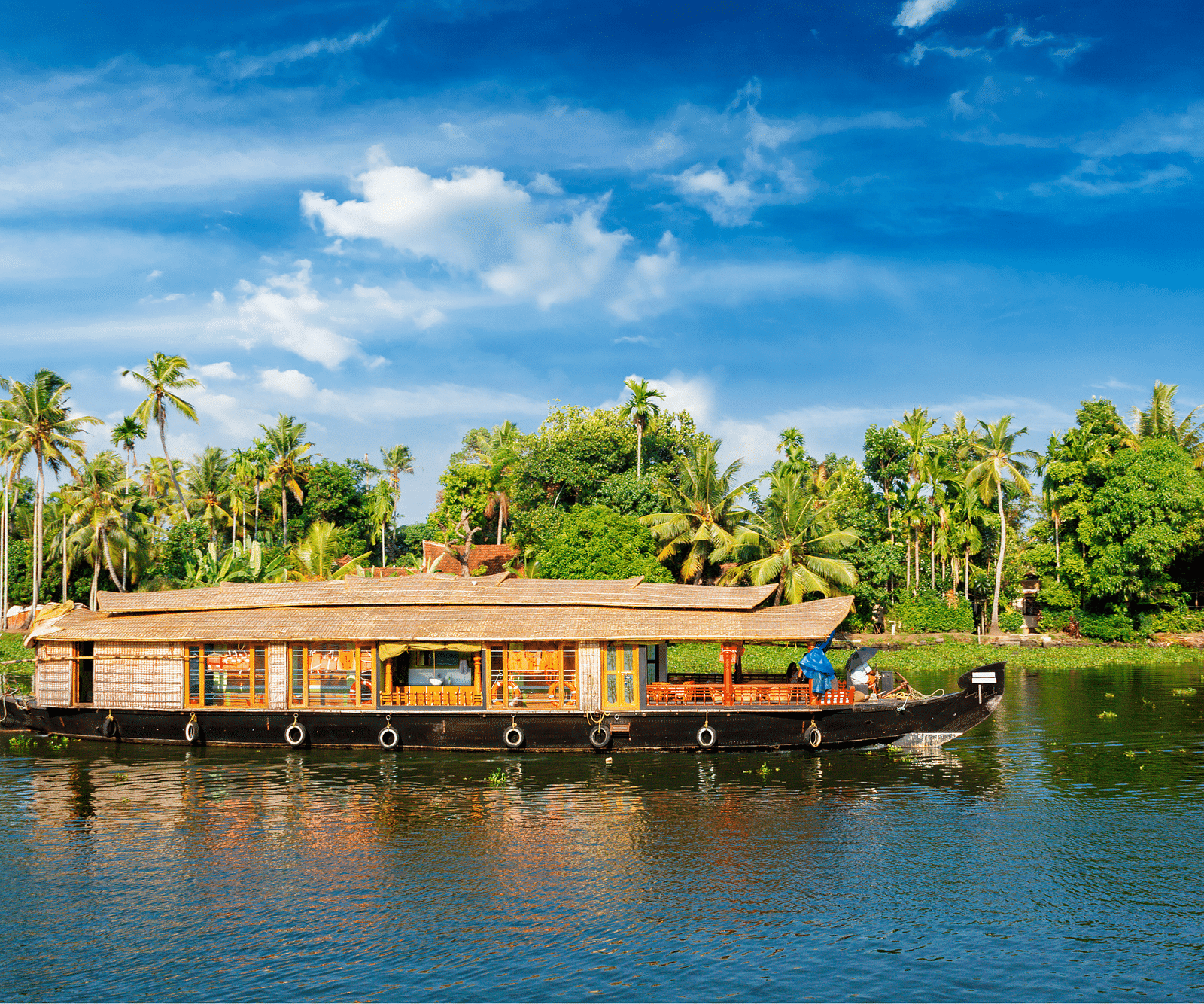 an image of a moving houseboat on the backwater - Rhythm Kumarakom