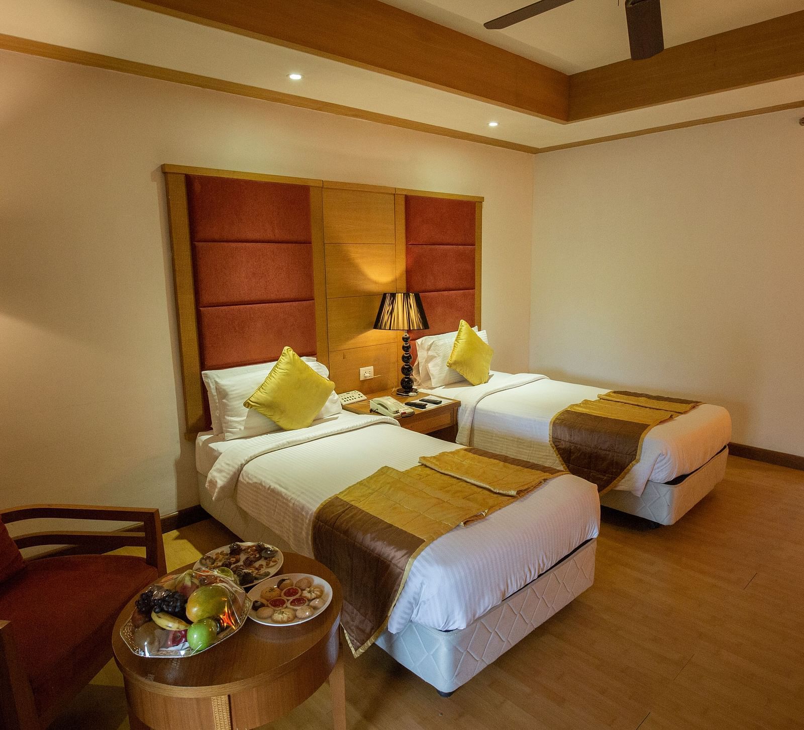 OS-CASCADE room with twin bed and wooden headboard at Ocean Spray Puducherry