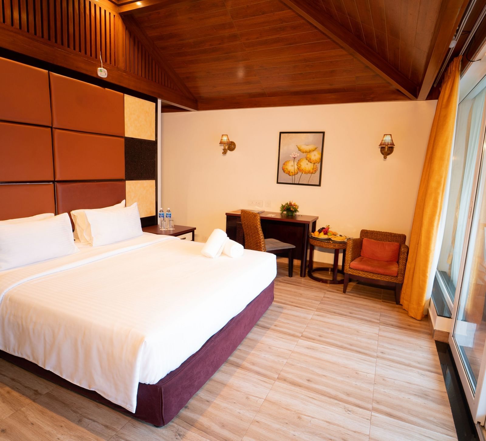 Santorini Villa with a balcony, queen size bed and wooden headboard at Ocean Spray Puducherry
