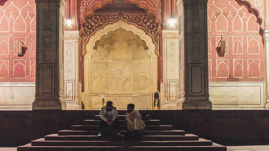 people sitting on the temple entrance with the temple in the background