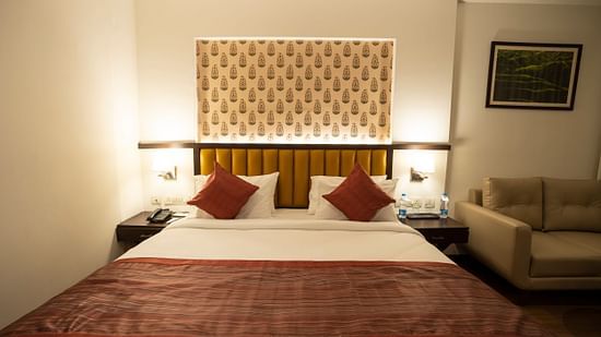 Superior room with a double bed and a sofa at Grand Continent, Secunderabad