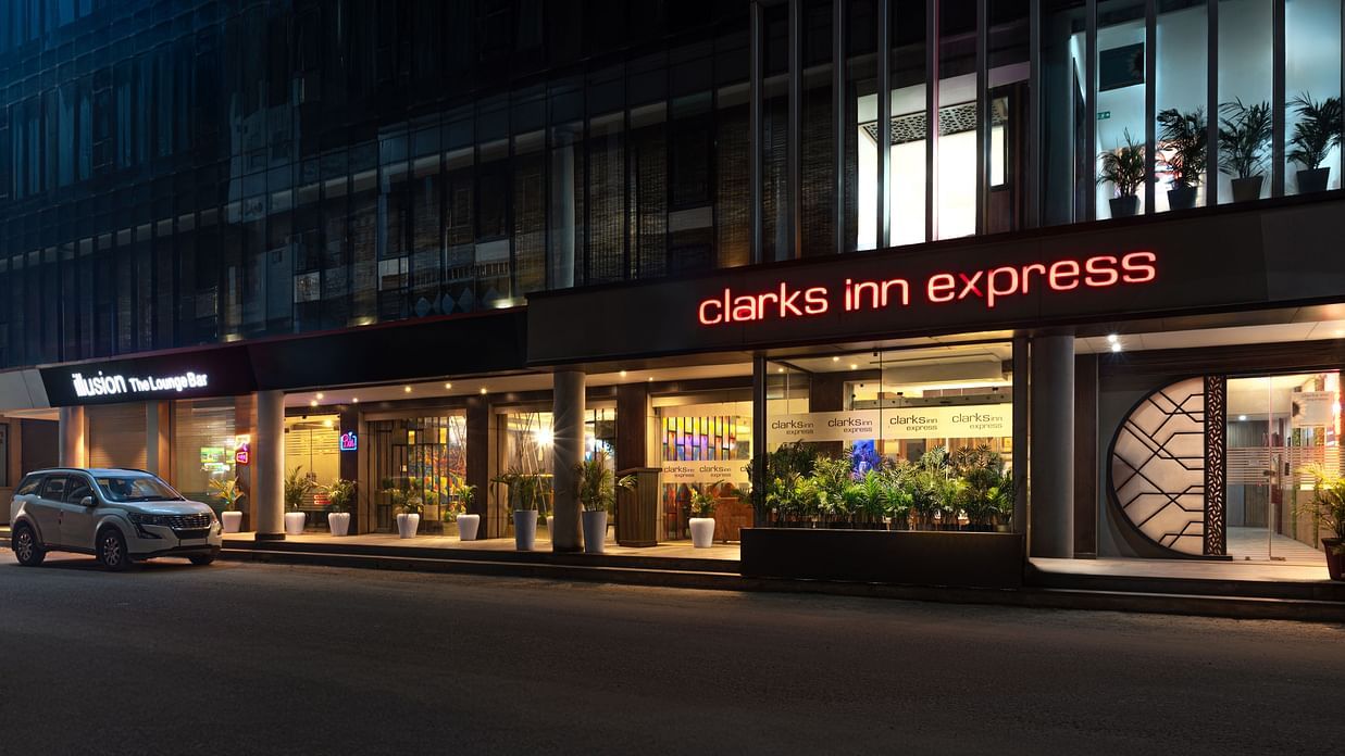  The exterior of  Clark Inn Express hotel with bright signage, showcasing its modern architecture and inviting entrance at night - Clarks Inn Express, Near Jammu Bari Brahmana Railway Station