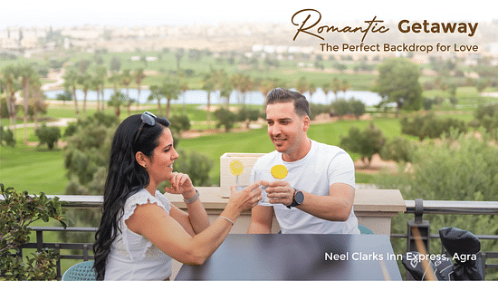 Banner for Romantic Getaway for Neel Clarks Inn Express featuring a couple clinking their beverage glasses at the table in the balcony