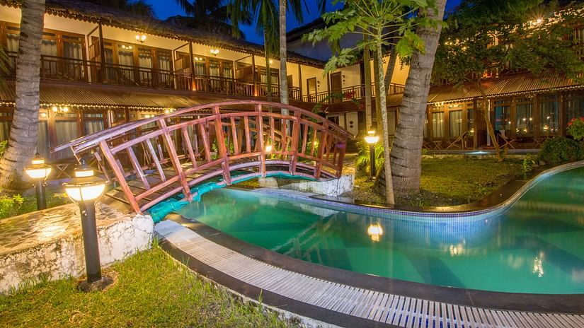Swimming pool at Symphony hotel in Neil Island with a wooden bridge over it