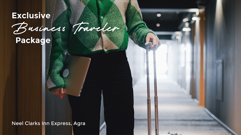 Banner for Business Traveler package for Neel Clarks Inn Express in Agra featuring a person holding a laptop in one hand and the handle of a travel bag in another