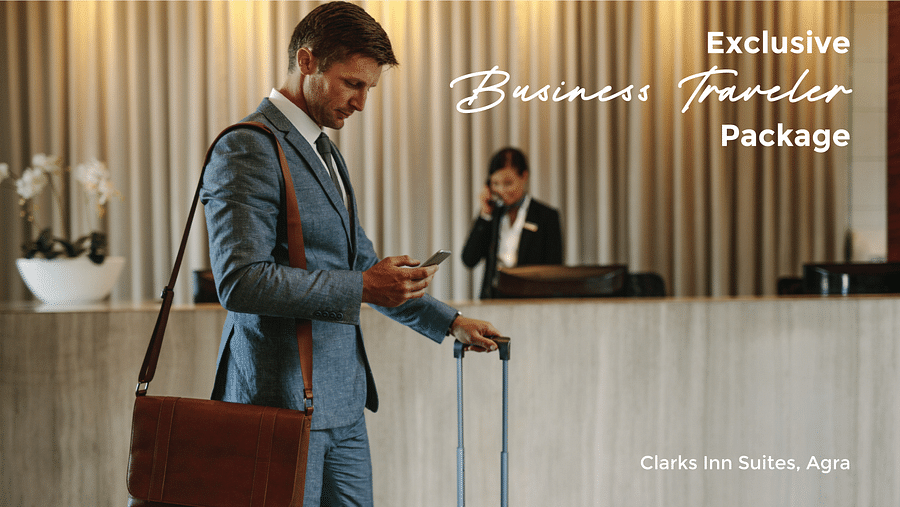 Banner of Business Travel Package for Clarks Inn Suites in Agra featuring a business traveller in formals with luggage engaged in his cellphone standing next to the hotel reception and the text on the images says Exclusive Business Traveler Package - Turn 