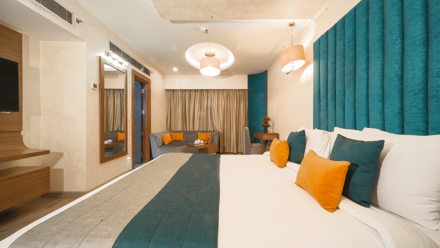 Executive Suite bedroom at The Suryaa New Delhi facing the window and refined interiors