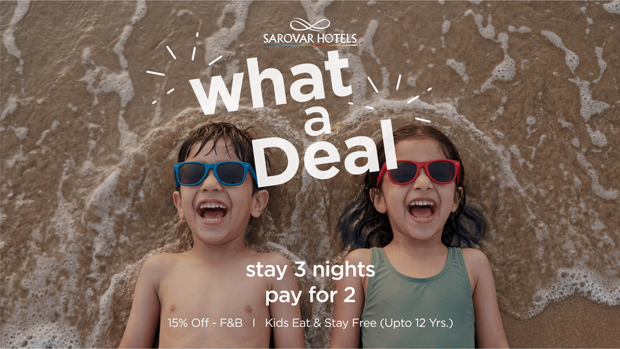 Sarovar Hotels What a Deal offer banner with two kids on the beach, stay 2 nights get the 3rd night free plus 15% off on F&B and kids up to 10 stay free.