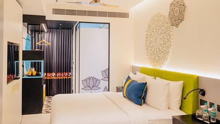 side view of a bedroom with tea and coffee maker at Zibe Luxe Kakinada by GRT Hotels