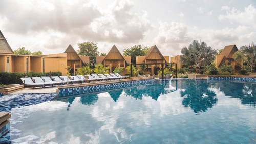 An overview of Jagira Ananta Elite, Gir with rooms in the distance and the swimming pool in the foreground