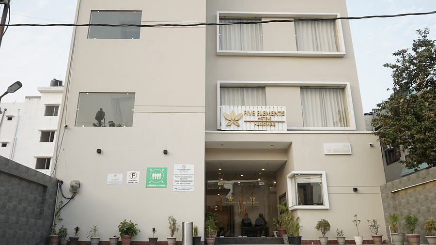 Facade of Five Elements Hotels, Haridwar, featuring the entrance pathway leading to the hotel