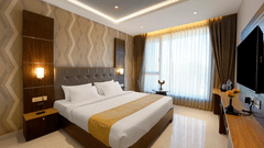 view of the king size bed facing the TV - the twin room offering twin beds with bedside lights facing the TV - Hotel Gwen by Rivido, Near Bannerghatta Road