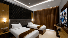 twin beds facing the TV at the premium room -Hotel Gwen by Rivido, Near Bannerghatta Road