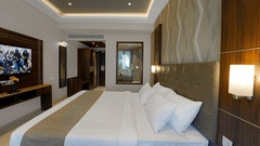 Modern deluxe room with a king-size bed, warm lighting, and stylish interiors at Avora Tree Hotel designed for a comfortable and relaxing stay.