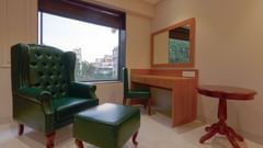 High Back Chairs and a table in a room with a window