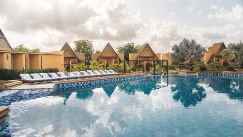 An overview of Jagira Ananta Elite, Gir with rooms in the distance and the swimming pool in the foreground