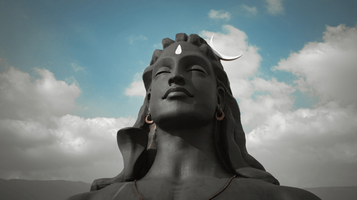 an image featuring a statue of lord shiva with a cloudy sky in the backround