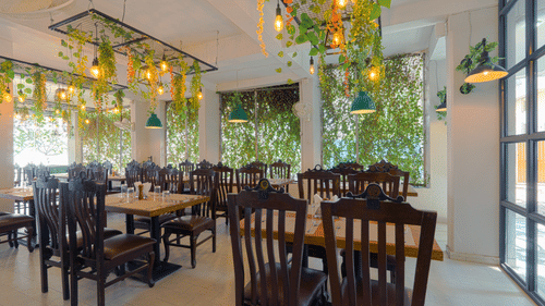 Puiicture featuring the dining area, well arranged tables and chairs - Magnus Aerith Studio, Kharadi